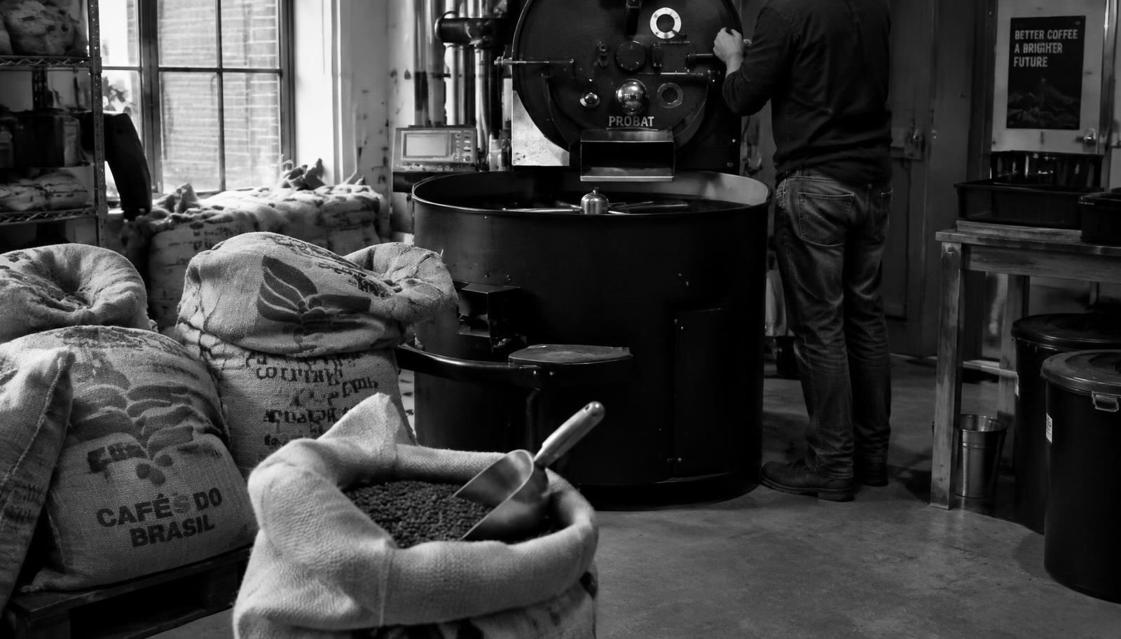 Coffee sacks and a roasting machine in a small roastery