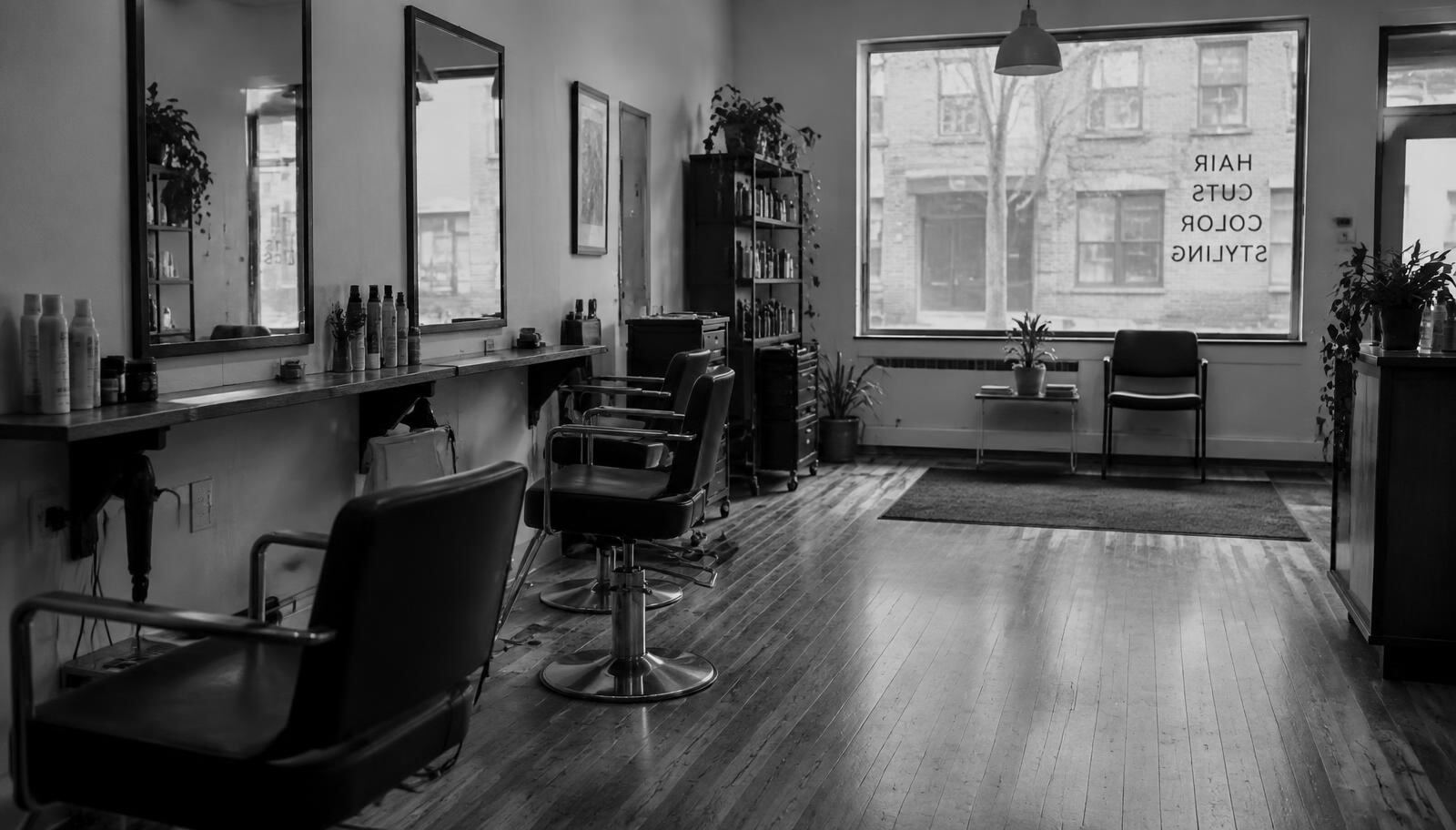 Empty chairs and mirrors in a small hair salon